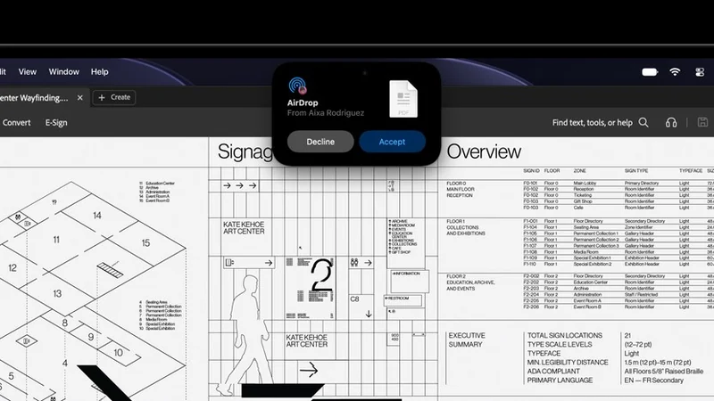 MacBook Pro 屏幕顶部的灵动岛显示一条隔空投送请求，来自 Alexa Rodriguez，附一个 PDF 文件，下方有拒绝与接受两个按钮，背景是 Numbers 表格