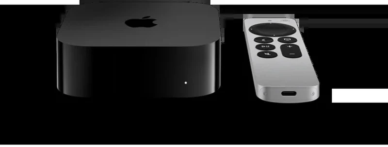 现款 Apple TV 4K 主机与 Siri Remote 的官方 45 度侧视渲染图,黑色主机正面可见状态指示灯,银色遥控器平放于右侧