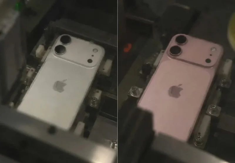 银色与粉色两款 iPhone 18 工程机并排放在产线夹具上,背面均为横向双摄镜组