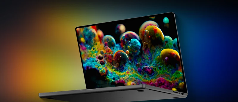MacBook Pro 概念渲染图：深灰色机身半开，屏幕显示彩色气泡状抽象画面，屏幕顶部为完整一整块玻璃没有刘海，背景为深色渐变