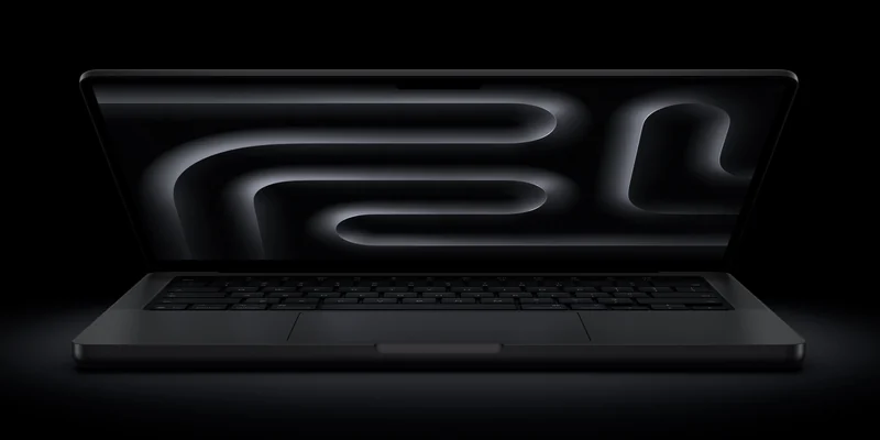 苹果官方渲染图:一台半开的 MacBook Pro 侧面视角,机身背后是发光的 M6 字样,背景为纯黑
